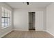 Bedroom with wood-look floors, closet, and window offering natural light at 3936 Applecrest St, Las Vegas, NV 89108