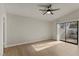 Bright bedroom featuring hardwood floors, ceiling fan, and sliding glass door to the backyard at 3936 Applecrest St, Las Vegas, NV 89108