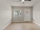 Bedroom featuring hardwood floors, a ceiling fan, window and door to the backyard at 3936 Applecrest St, Las Vegas, NV 89108