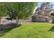 Well-maintained front yard with lush green grass and mature shade trees at 3936 Applecrest St, Las Vegas, NV 89108