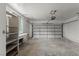 Spacious garage with a workbench, shelving, and natural light from the window at 3936 Applecrest St, Las Vegas, NV 89108