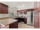 Cozy kitchen featuring stainless steel appliances, brown cabinets, and a window for natural light at 3936 Applecrest St, Las Vegas, NV 89108