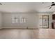 Open-concept living room with wood floors, tile transition, neutral walls, and sliding glass doors at 3936 Applecrest St, Las Vegas, NV 89108