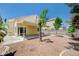 Inviting backyard featuring a covered patio, mature trees, and low-maintenance landscaping under a clear blue sky at 420 Clifton Heights Dr, Las Vegas, NV 89145