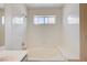A well-lit bathroom area features a bathtub, a shower, a bench, and white tiling at 420 Clifton Heights Dr, Las Vegas, NV 89145
