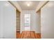 Walk-in closet with shelving and hardwood floors, with a view of a nearby bathroom at 420 Clifton Heights Dr, Las Vegas, NV 89145