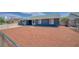 The backyard features a spacious area with minimalistic landscaping enclosed by a chain-link fence at 4425 Sherrill Ave, Las Vegas, NV 89110