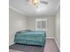 A simple bedroom with a ceiling fan, carpet, and a window at 4425 Sherrill Ave, Las Vegas, NV 89110