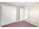 Cozy bedroom featuring neutral walls, a closet and an entrance door for a clean, minimalist design at 4425 Sherrill Ave, Las Vegas, NV 89110