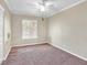 Bright bedroom features neutral walls, carpet, window, ceiling fan and a white trim at 4425 Sherrill Ave, Las Vegas, NV 89110