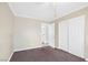 A cozy bedroom with neutral-toned walls, carpet and closet and an open doorway at 4425 Sherrill Ave, Las Vegas, NV 89110