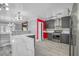 Contemporary kitchen featuring a breakfast bar, stainless steel appliances, and modern lighting at 4425 Sherrill Ave, Las Vegas, NV 89110