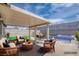 Outdoor patio features comfortable seating around a table with the pool in the background at 4425 Sherrill Ave, Las Vegas, NV 89110