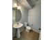 Neat half-bathroom with tile flooring, pedestal sink, and toilet at 4749 Golden Shimmer Ave, Las Vegas, NV 89139