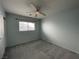 Bedroom featuring a window, neutral carpet, and a ceiling fan for optimal comfort at 4749 Golden Shimmer Ave, Las Vegas, NV 89139