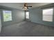 Spacious bedroom with soft carpet and bright natural lighting from multiple windows at 4749 Golden Shimmer Ave, Las Vegas, NV 89139