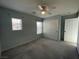 Well-lit bedroom with carpet, ceiling fan, and windows at 4749 Golden Shimmer Ave, Las Vegas, NV 89139