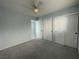 Cozy bedroom featuring neutral carpet, a ceiling fan, and double closet doors for ample storage at 4749 Golden Shimmer Ave, Las Vegas, NV 89139