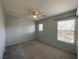 Bright bedroom with neutral carpet, a ceiling fan, and large windows for natural light at 4749 Golden Shimmer Ave, Las Vegas, NV 89139