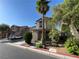 A charming two-story home has a palm tree and small yard with decorative rock landscaping at 4749 Golden Shimmer Ave, Las Vegas, NV 89139