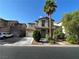 Two-story home with an attached garage, complemented by a palm tree and front yard landscaping at 4749 Golden Shimmer Ave, Las Vegas, NV 89139