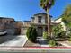 A two-story house with a palm tree in the front yard is shown on a sunny day at 4749 Golden Shimmer Ave, Las Vegas, NV 89139
