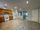 Eat-in kitchen featuring wood cabinets, white appliances, recessed lighting, and tiled floors at 4749 Golden Shimmer Ave, Las Vegas, NV 89139
