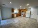 Eat-in kitchen featuring wood cabinets, white appliances, recessed lighting, and tiled floors at 4749 Golden Shimmer Ave, Las Vegas, NV 89139