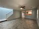 Cozy living room with staircase, tile flooring, and view to the kitchen at 4749 Golden Shimmer Ave, Las Vegas, NV 89139
