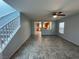Inviting living room featuring tile flooring, ceiling fan, and open access to the kitchen at 4749 Golden Shimmer Ave, Las Vegas, NV 89139
