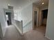 Upstairs hallway with neutral carpet, windows, and access to rooms at 4749 Golden Shimmer Ave, Las Vegas, NV 89139