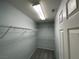 Bright walk-in closet with metal shelving and neutral gray carpet, perfect for organized storage at 4749 Golden Shimmer Ave, Las Vegas, NV 89139