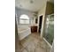 Well-lit bathroom with a soaking tub, glass-enclosed shower, tile flooring, and vanity with sink at 5524 Markley Ave, Las Vegas, NV 89141