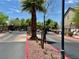 Community entrance gate with brick pathway, mature trees, and landscaping at 5524 Markley Ave, Las Vegas, NV 89141