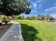 Expansive community park featuring lush grass, walking paths, and scattered landscaping at 5524 Markley Ave, Las Vegas, NV 89141