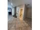 Open-concept floorplan featuring tile flooring, neutral walls, and half bathroom at 5524 Markley Ave, Las Vegas, NV 89141