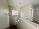 Bright hallway with neutral walls, a modern light fixture, and access to the upper level and another room at 5524 Markley Ave, Las Vegas, NV 89141
