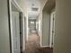 Upstairs hallway with carpet floors, neutral walls, and a series of windows letting in natural light at 5524 Markley Ave, Las Vegas, NV 89141