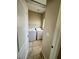 Functional laundry room featuring tile flooring, shelving, and modern washer and dryer units at 5524 Markley Ave, Las Vegas, NV 89141