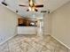 Cozy living area with tile floors, a ceiling fan, and seamless flow into the kitchen for easy living at 5524 Markley Ave, Las Vegas, NV 89141