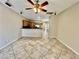 Open-concept living area with tile floors, a ceiling fan, and seamless flow into the kitchen for easy living at 5524 Markley Ave, Las Vegas, NV 89141