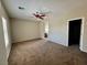 Expansive main bedroom with neutral walls, plush carpeting, ceiling fan, and ensuite bathroom access at 5524 Markley Ave, Las Vegas, NV 89141