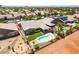 An aerial view of the home featuring a backyard pool, desert landscaping, and covered patio at 5586 Golden Leaf Ave, Las Vegas, NV 89122