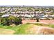 Aerial view of a neighborhood overlooking a golf course and homes with pools at 5586 Golden Leaf Ave, Las Vegas, NV 89122