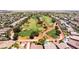 Aerial view of an expansive golf course surrounded by numerous single-Gathering homes at 5586 Golden Leaf Ave, Las Vegas, NV 89122