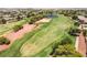 Aerial view of a lush green golf course with a community pond at 5586 Golden Leaf Ave, Las Vegas, NV 89122