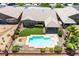 An aerial view of a backyard featuring a pool, desert landscaping, and a grassy lawn at 5586 Golden Leaf Ave, Las Vegas, NV 89122