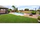 Pool and desert landscaping in backyard with grassy area, plus a wrought iron fence at 5586 Golden Leaf Ave, Las Vegas, NV 89122