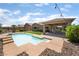 An overview of backyard showcasing pool, covered patio, and desert landscaping at 5586 Golden Leaf Ave, Las Vegas, NV 89122