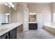 Primary bathroom featuring a double vanity, tub, and walk-in shower at 5586 Golden Leaf Ave, Las Vegas, NV 89122